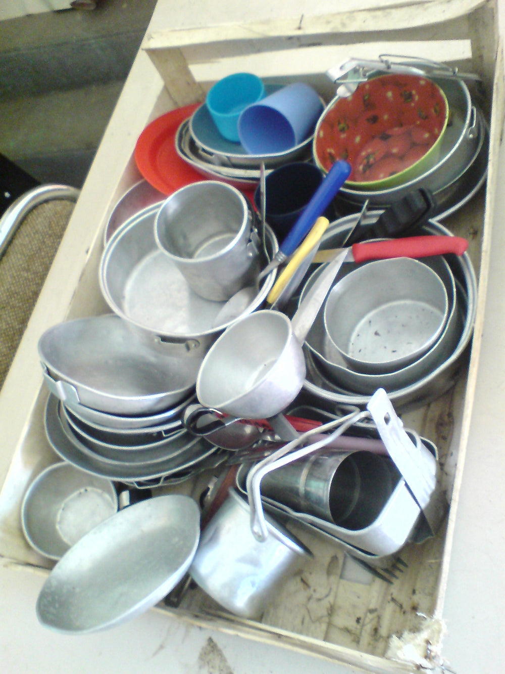 Camping cookware including nesting pots, bowls and cups.