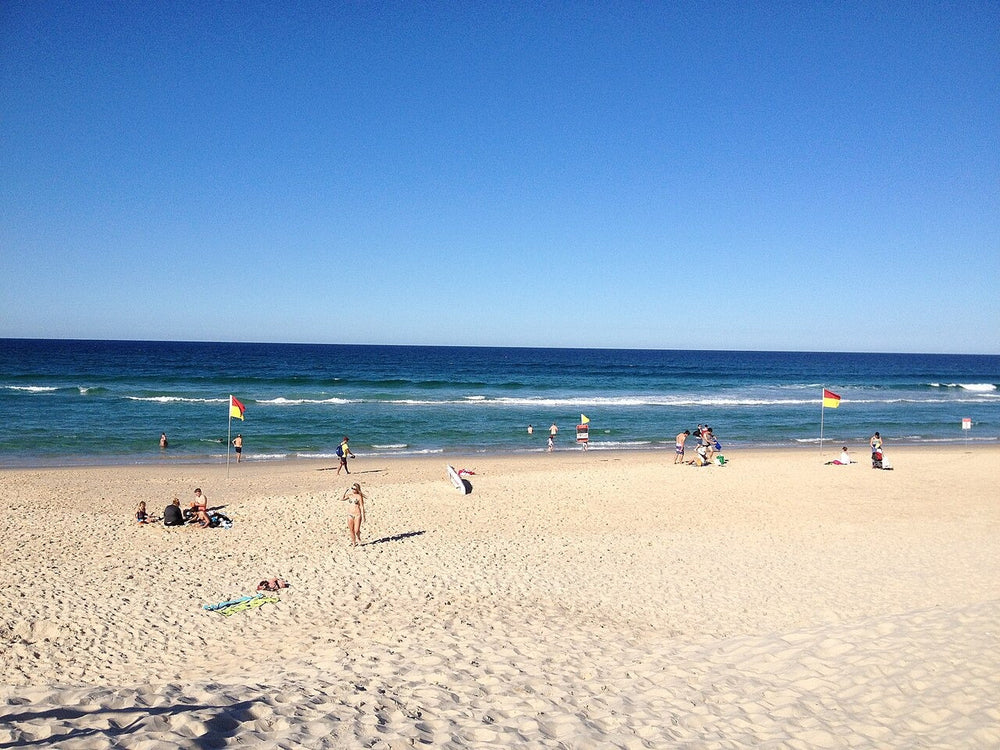 Red and yellow swimming flags on a patrolled beach in Queensland
