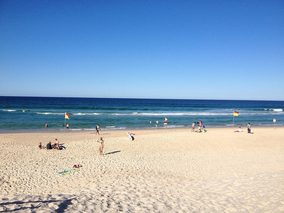 Red and yellow swimming flags on a patrolled beach in Queensland
