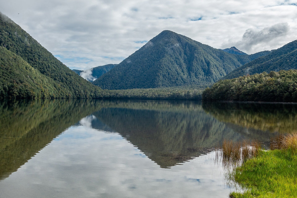 Forested hills reflected in Lake Daniell.