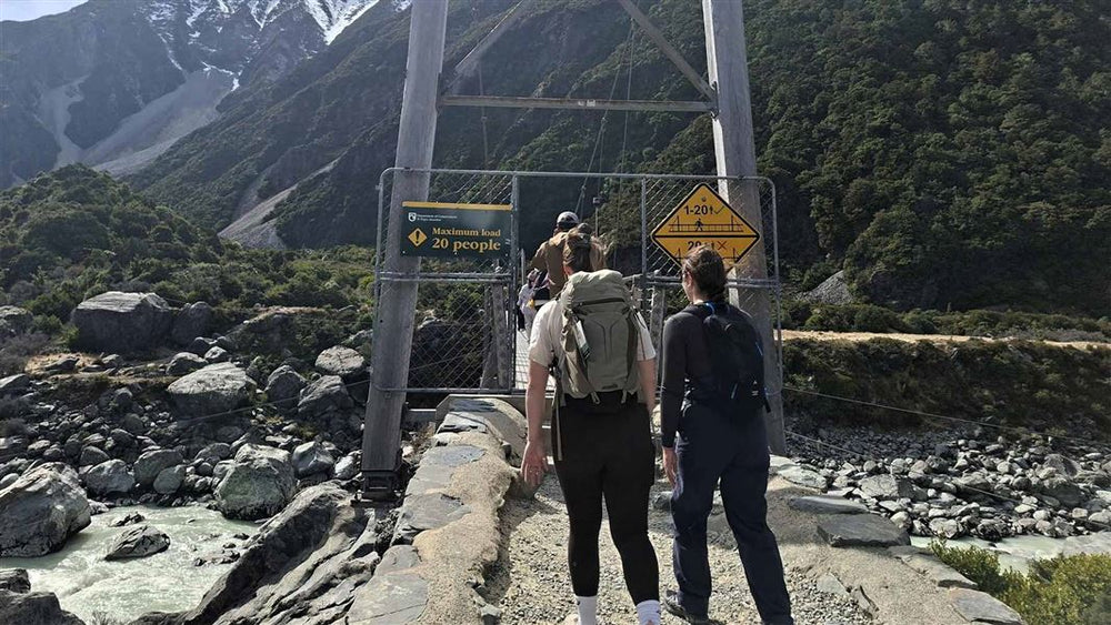 Signs at a Hooker Valley swing bridge. Photo: Jo Malcolm / DOC.