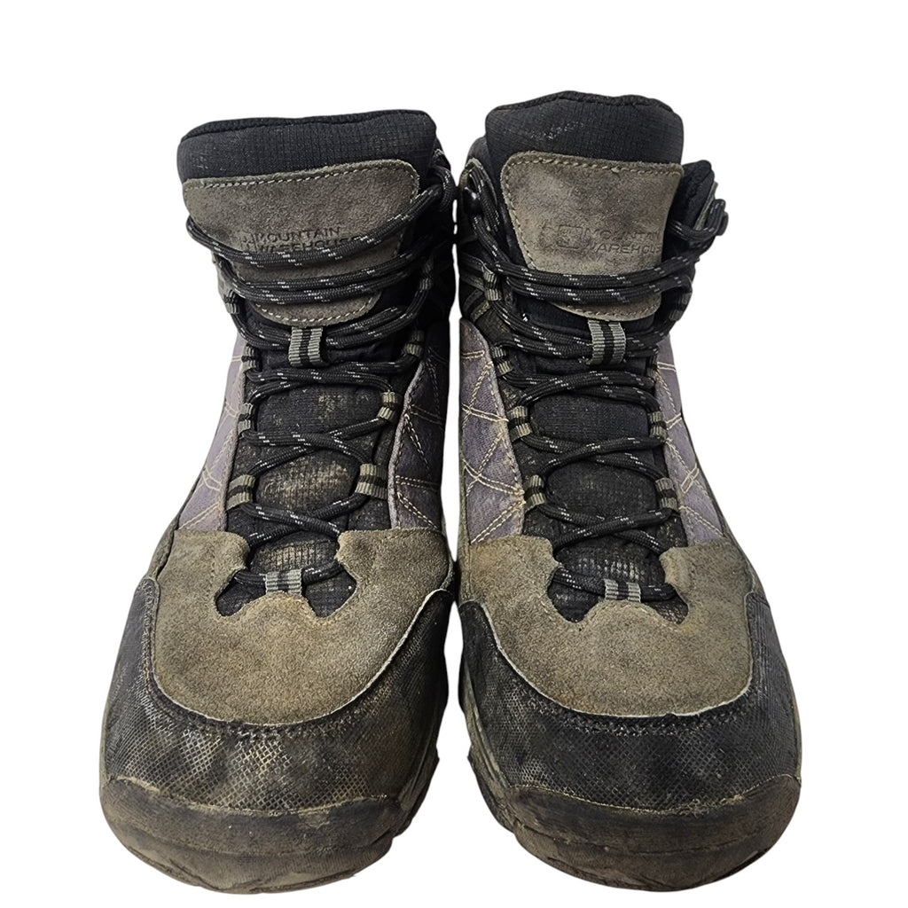 Pair of worn hiking boots on a white background