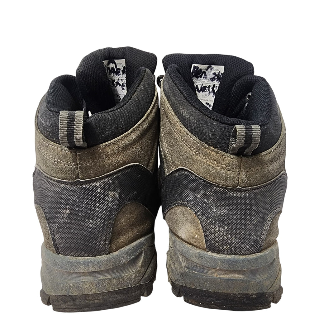 Pair of worn hiking boots on a white background