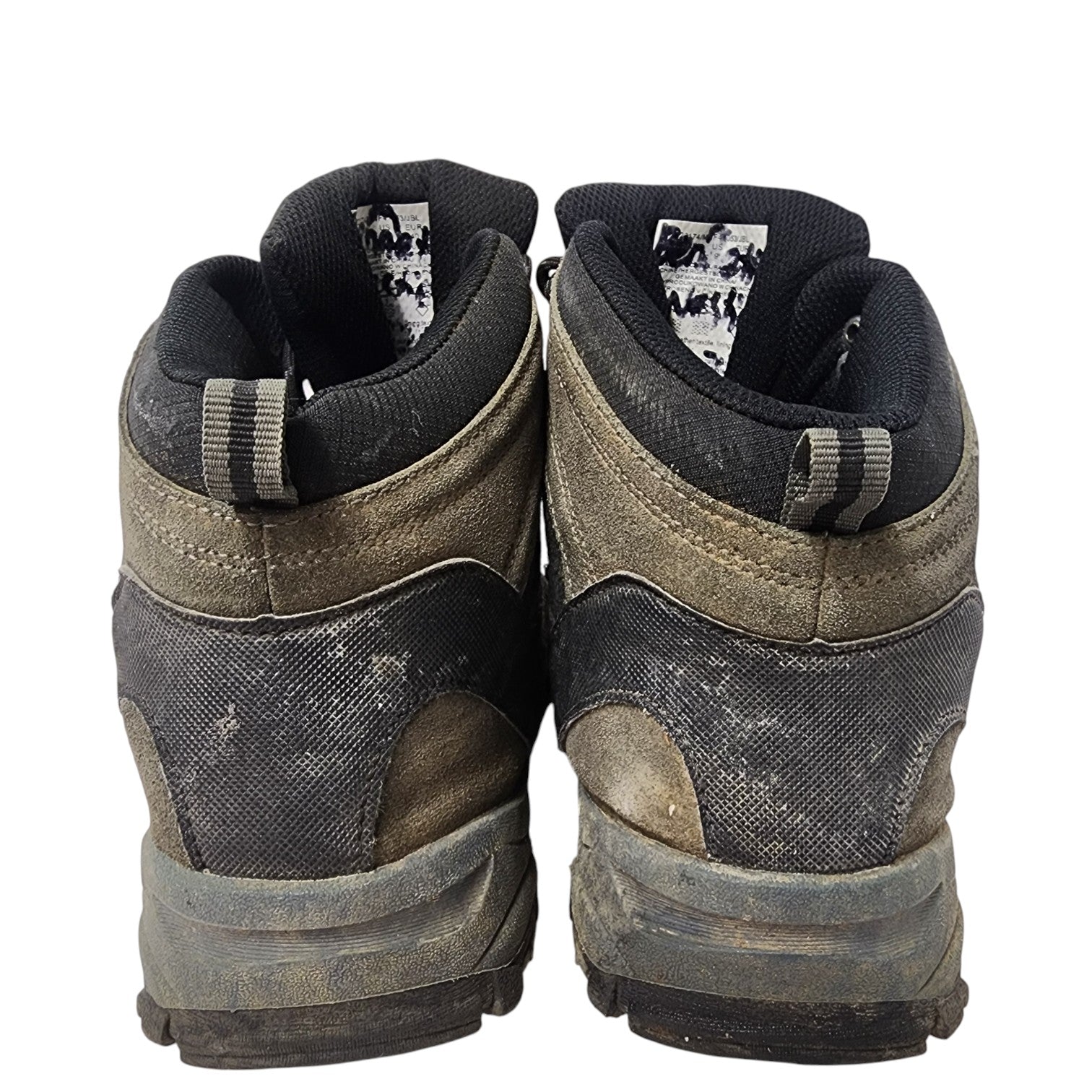 Pair of worn hiking boots on a white background