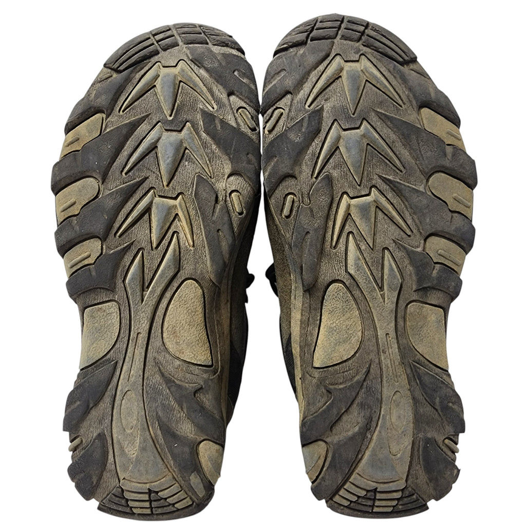 Close-up of a pair of brown hiking boots with tread pattern on a white background