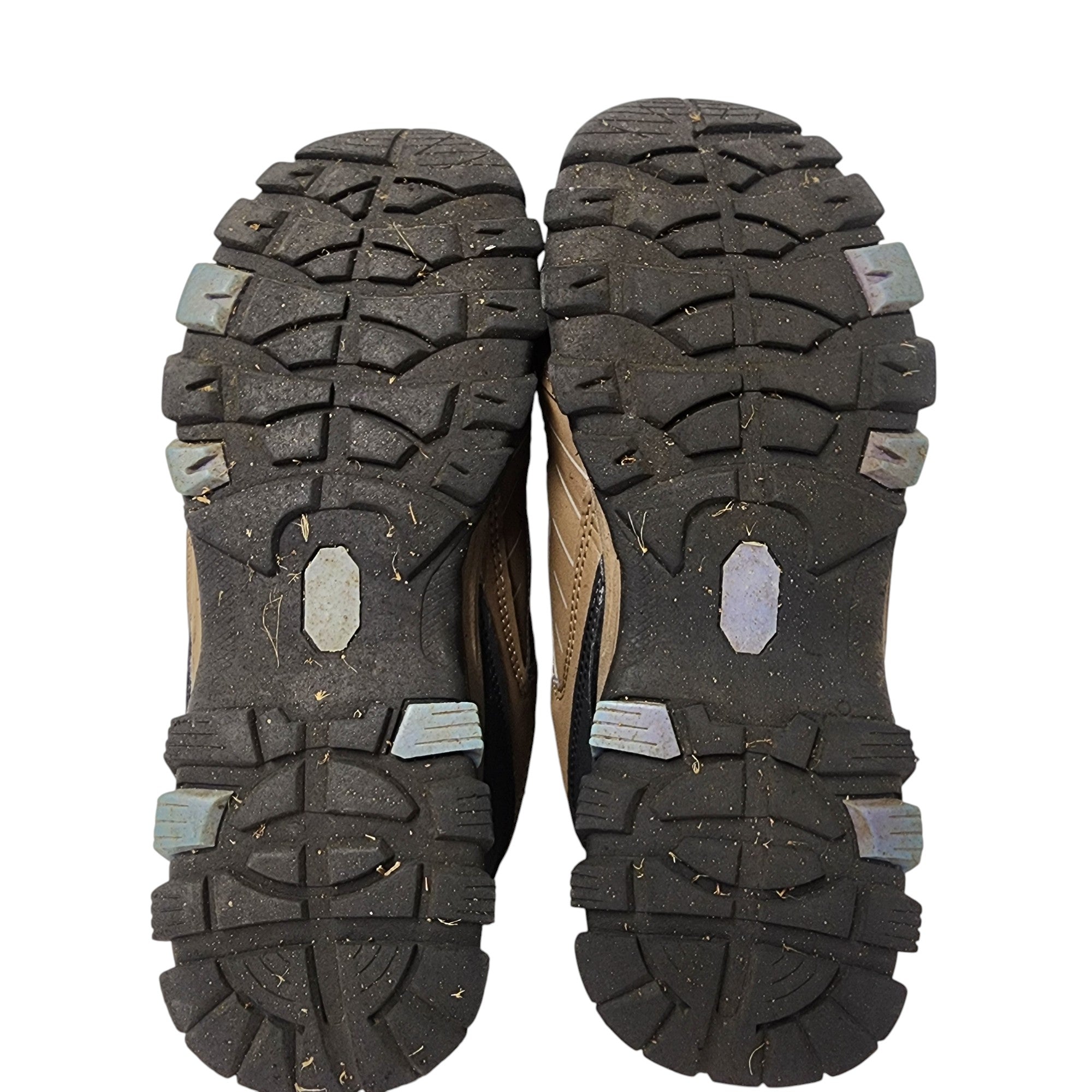 Close-up of the sole of a hiking shoe with tread pattern on a white background