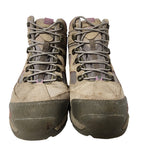 Pair of worn hiking boots on a white background