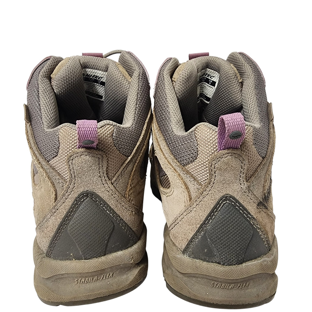 Pair of worn hiking boots on a white background