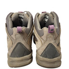 Pair of worn hiking boots on a white background