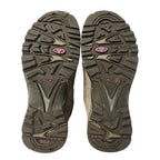 Close-up of hiking shoe soles with brand logo on a white background