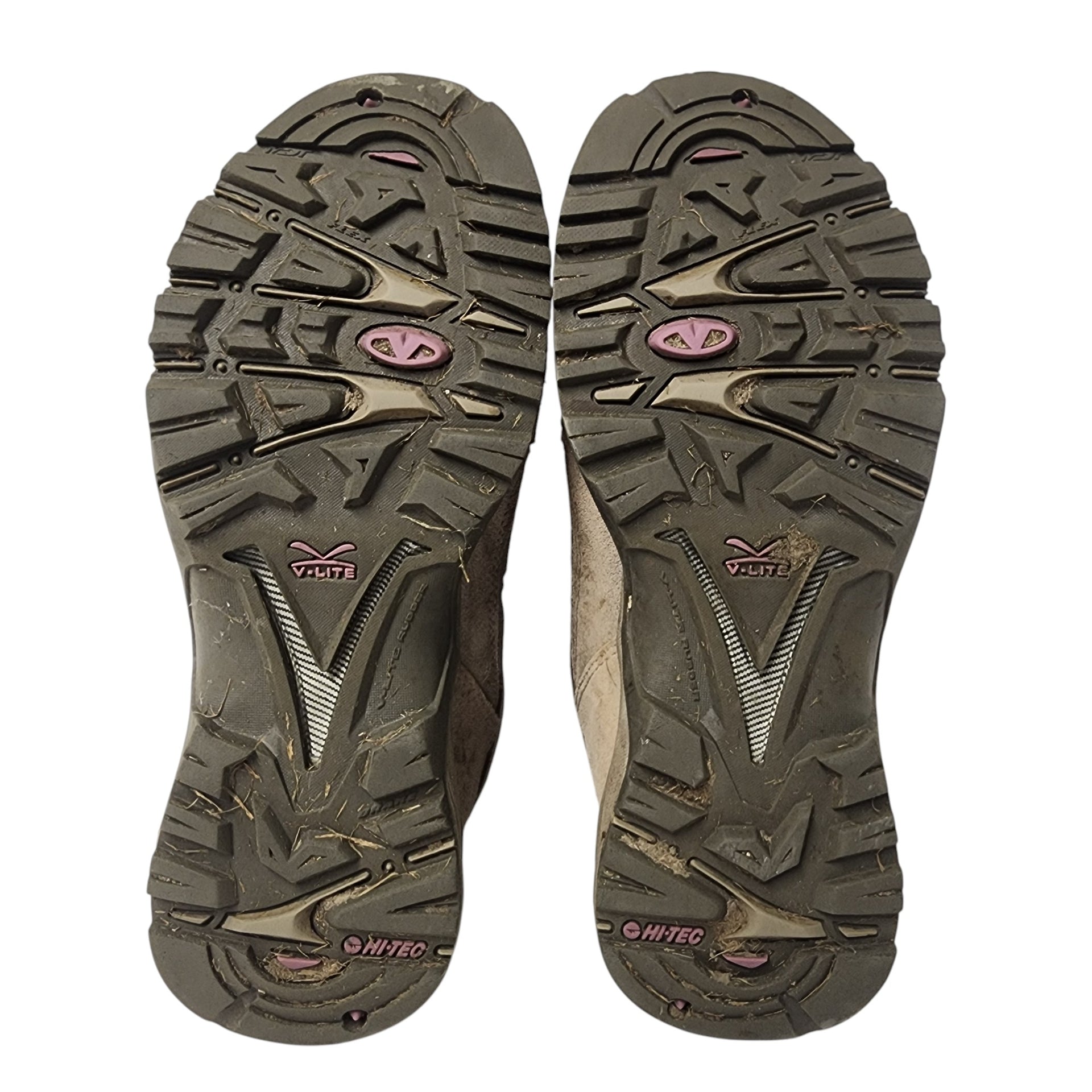 Close-up of hiking shoe soles with brand logo on a white background