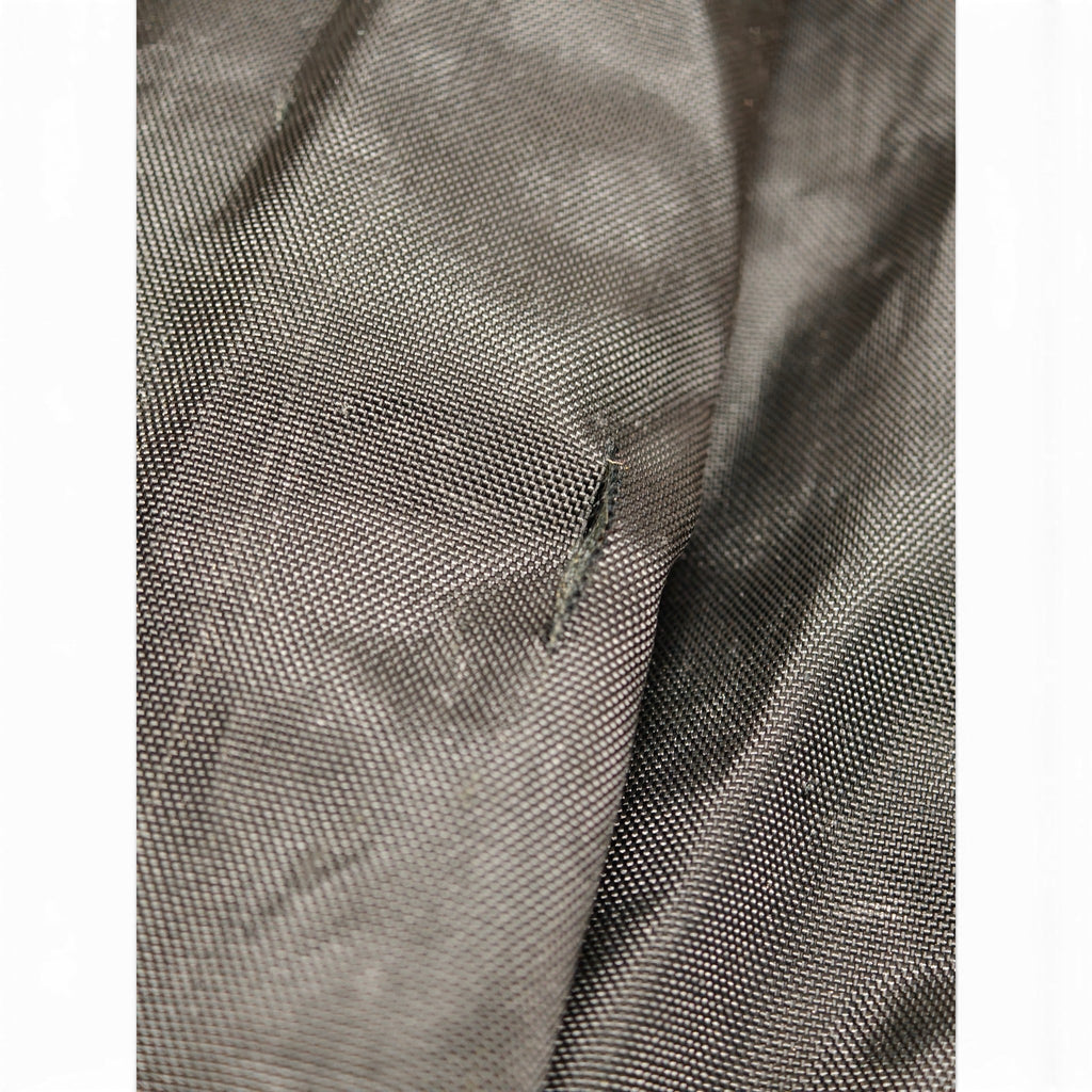 Tear in long black ski bag