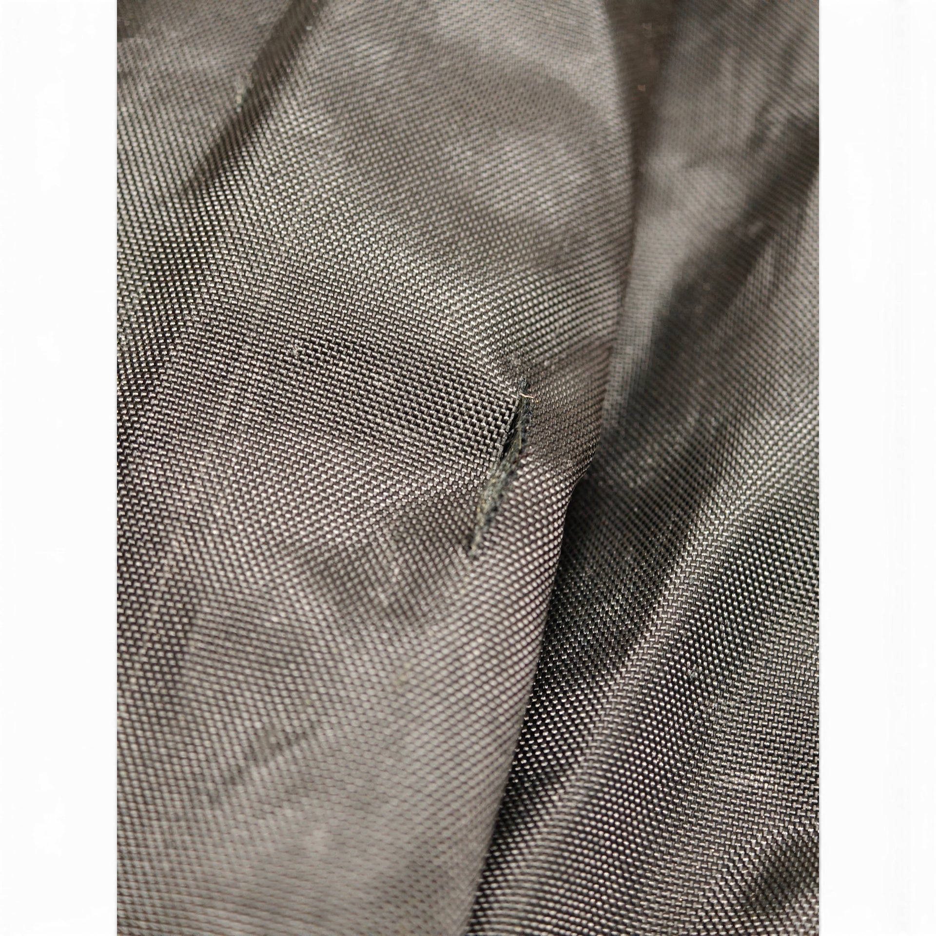 Tear in long black ski bag