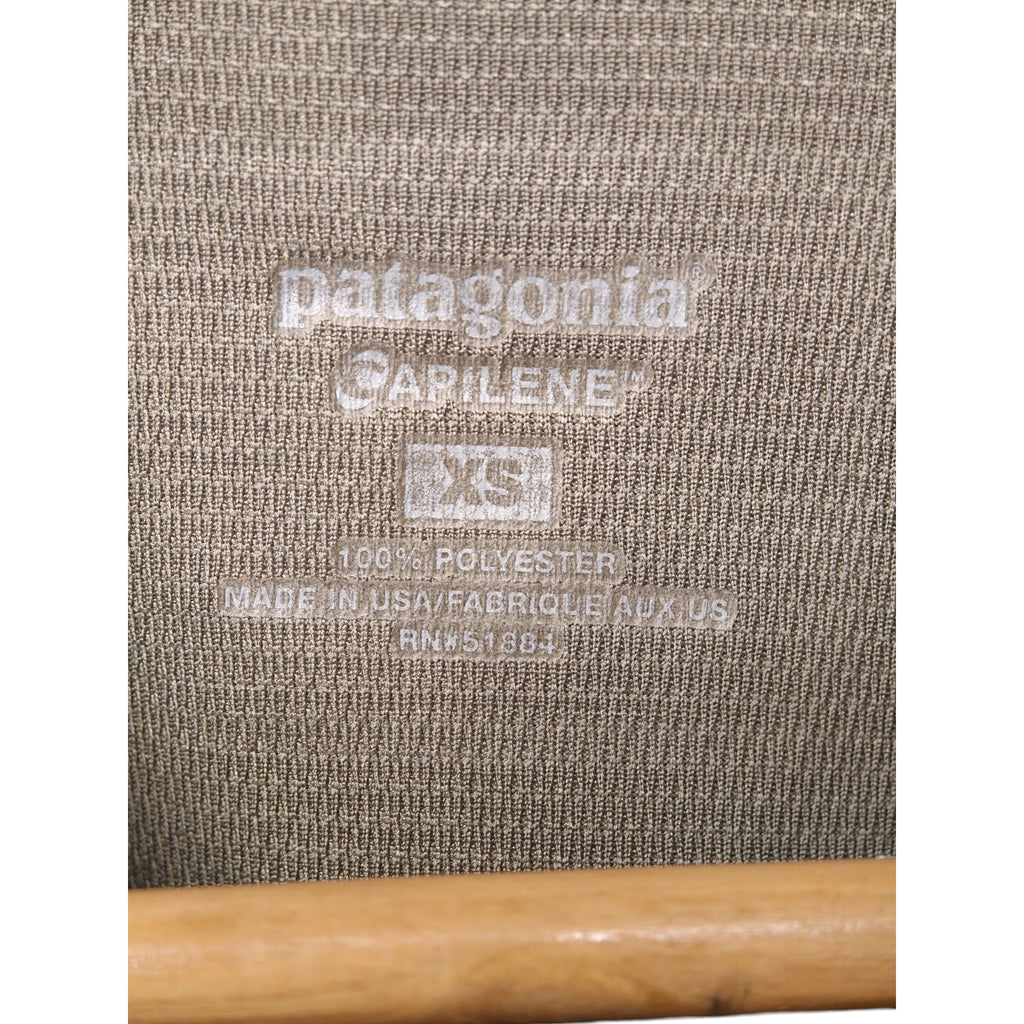 Label close-up showing Patagonia Capilene XS polyester made in USA
