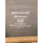 Label close-up showing Patagonia Capilene XS polyester made in USA