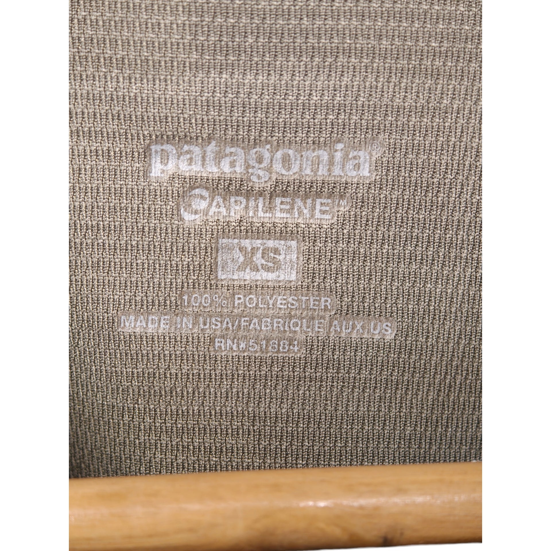 Label close-up showing Patagonia Capilene XS polyester made in USA