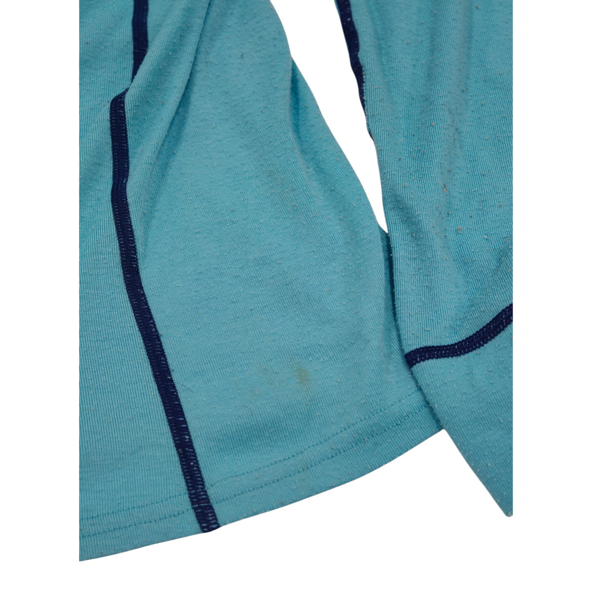 Close-up detail of Macpac aqua and navy long-sleeve base layer
