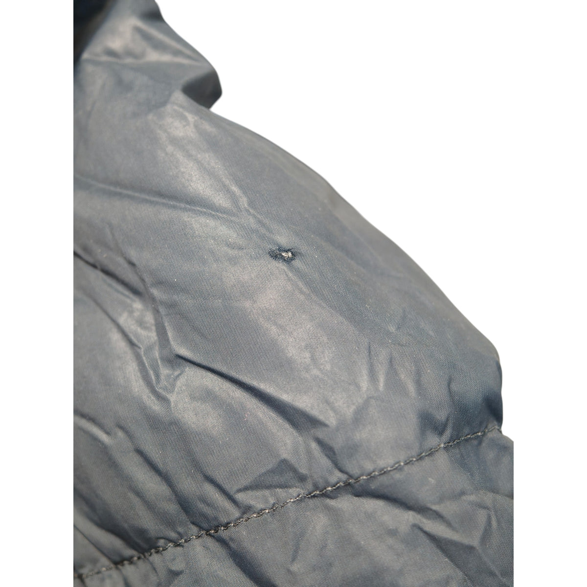 Close-up of the lining and seam on the Mountain Designs women's down jacket