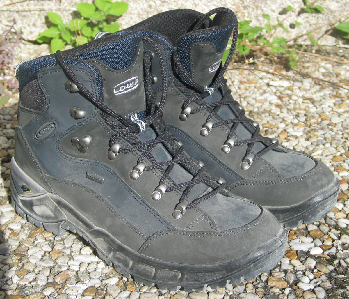 A pair of Lowa hiking boots, showing laces, collars and soles.