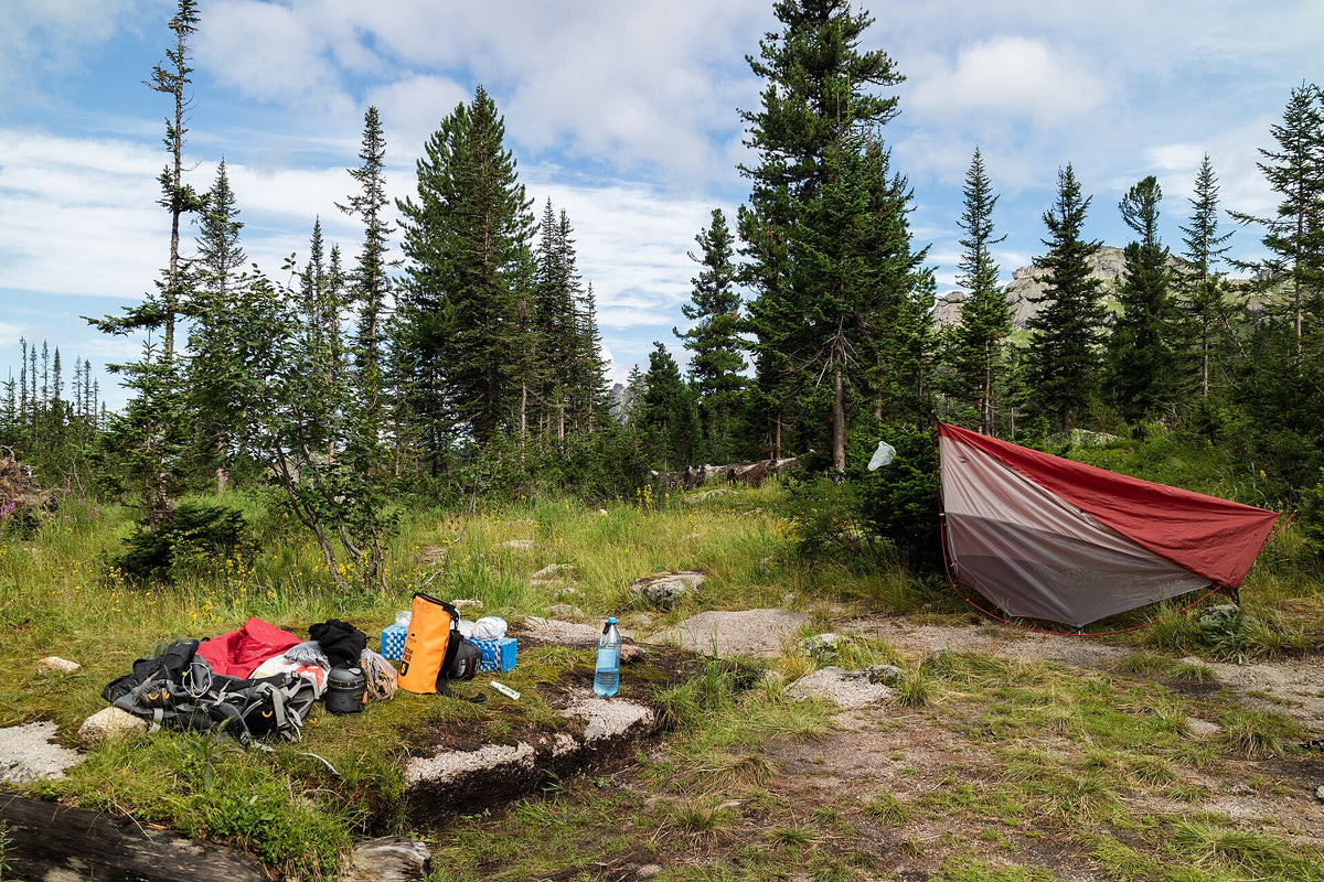 Camping equipment laid out beside a shelter in the Ergaki mountains, Russia.