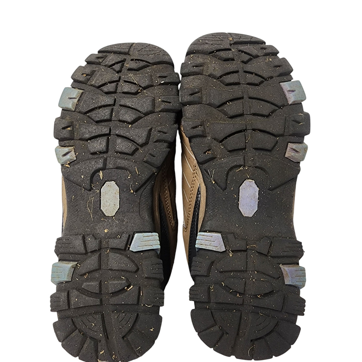 Close-up of the sole of a hiking shoe with tread pattern on a white background
