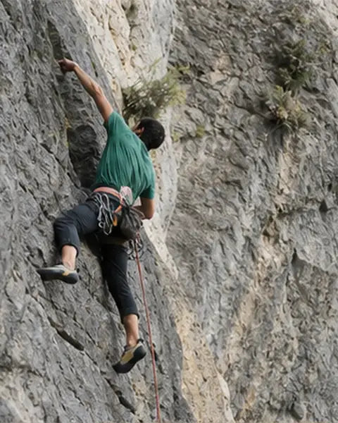 Rock climber using outdoor climbing equipment